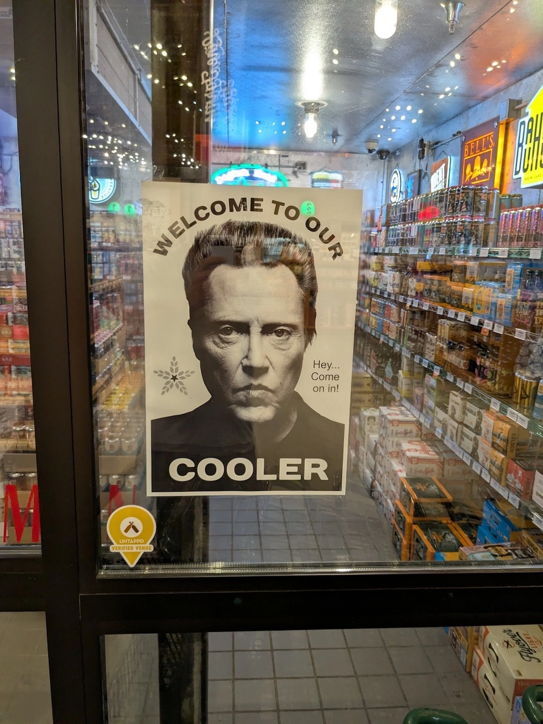 A sign on the door to a walk-in cooler, with a picture of Christopher Walken on the sign that says "Welcome to our (Walken photo) cooler."